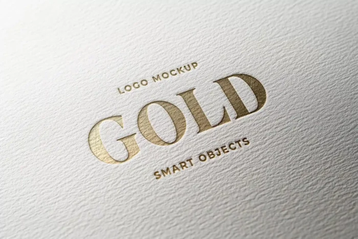 Free Emboss Gold Logo Mockup with luxurious embossed gold effect for premium brand presentations.