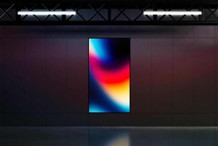 Free vertical LED screen mockup with industrial night setting for design presentations.