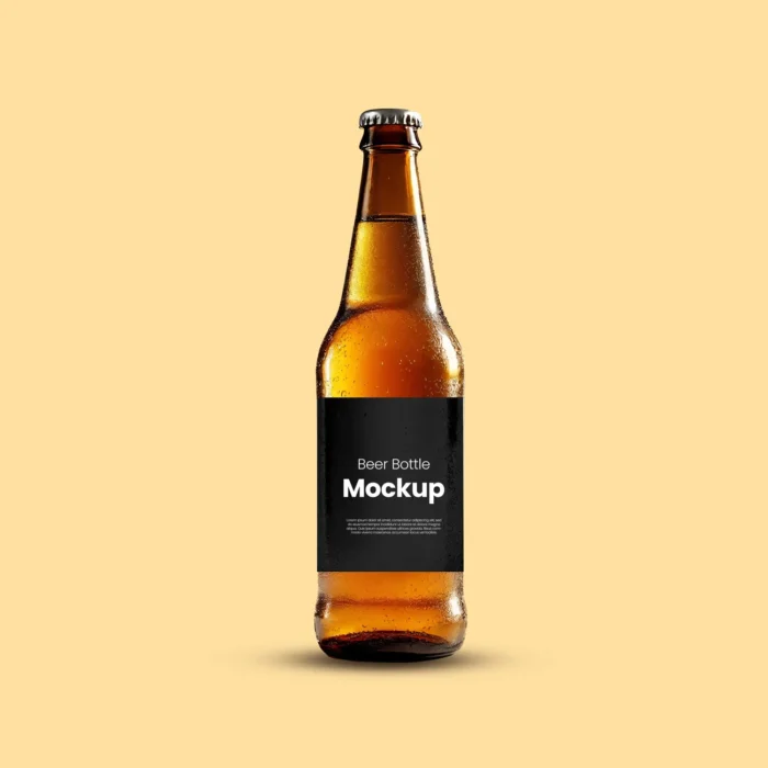 Realistic amber beer bottle mockup with water droplets and a customizable black label, displayed on a soft beige background.