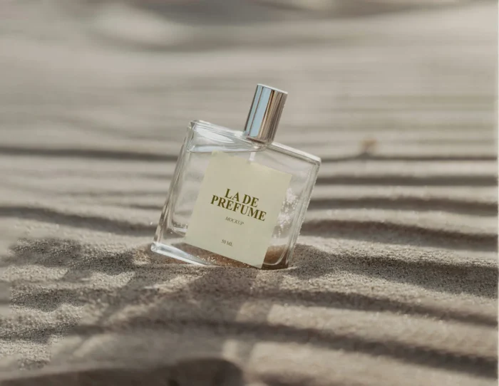 Free luxury glass perfume bottle mockup on sand