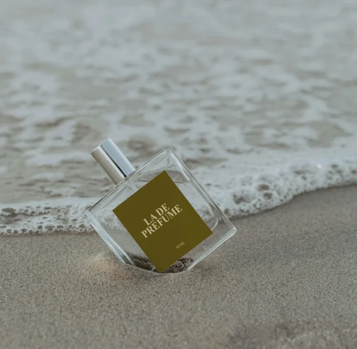 Free cosmetic perfume mockup at the beach in PSD format