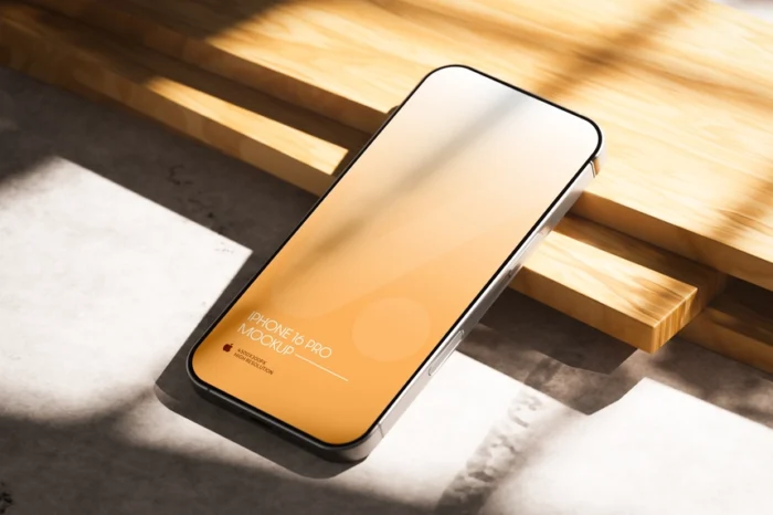 Free iPhone 16 Pro Mockup PSD on Wooden Table